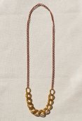 Vintage gold chain center attached to a copper chain.